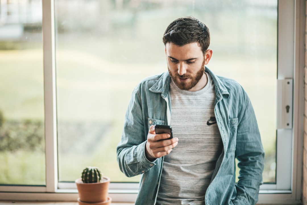 person looking at phone β Vitalheros